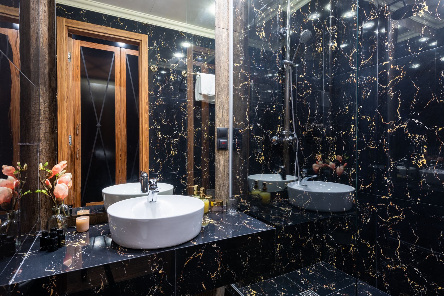 Black marble bathroom with heavy gold veining, the burnishing stage setting